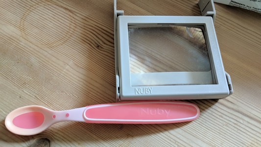 NUBY magnifying glass with light for original Game Boy, and Nûby baby spoon.