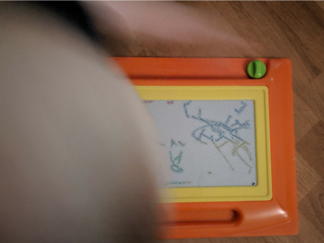 BeardGrabber about to erase his own Etch-a-sketch drawing.
