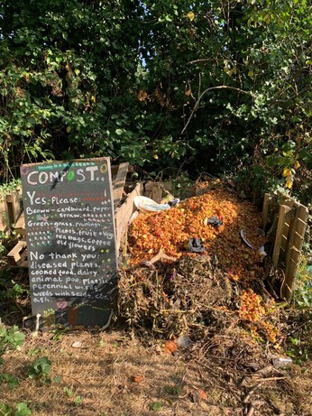 A compost heap with a list of instructions for suitable composting ingredients