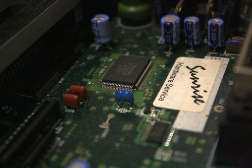 A close-up of an MSX circuit board with a sticker that reads "Sunrise Hardware Service".