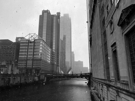 some buildings and the chicago river in the snow 