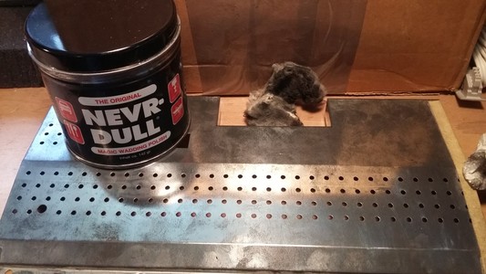 The separate metal plate from the 600XL with a box of nevr-dull on it.