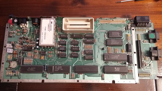 Unmodified but opened up Atari 600XL board. In the upper center the cartridge slot, big chips on the south, with the 3rd being the 6502. Joystick ports on the right.