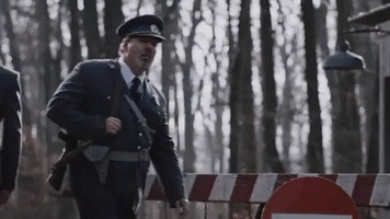 Video of guard walking and raising hand reminiscent of a mad dictator.