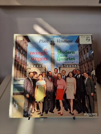A vinyl record of the modern jazz quartet and single sisters