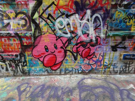 two kirbies dancing, one of them is smiling normally and the other is smirking while wearing black sunglasses