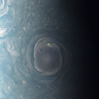 A flash of probable lightning in one of Jupiter's north polar cyclones