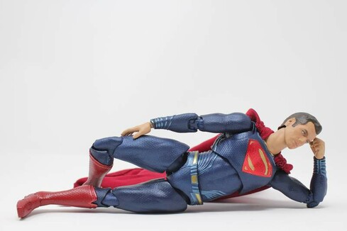 ⸻
⸻
Eine Superman-Figur, die am Boden liegt und den Kopf nachdenklich auf einen Arm stützt.
⸻