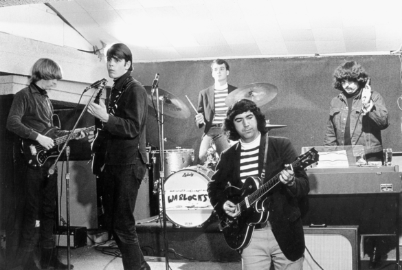 a very early photograph of the grateful dead playing live. 1965?