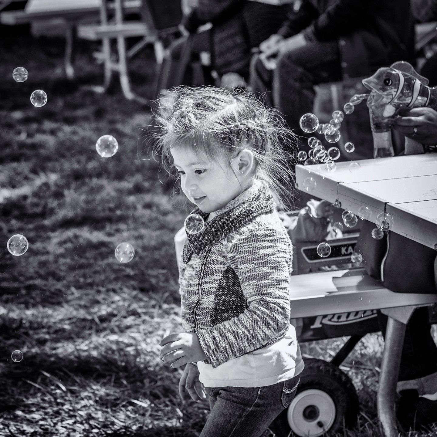 Little girl chasing soap bubbles