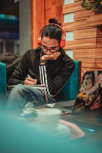 Persen with headphones grading papers