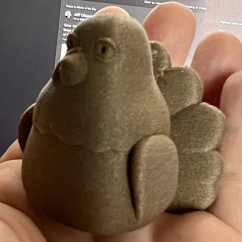 A hand holding a 3-D printed turkey
