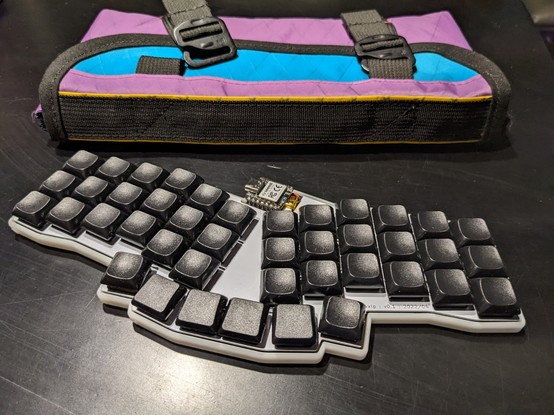 42 key keyboard with white case, and black deep dished keycaps.