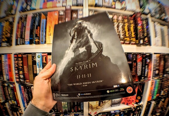 Photo showing an ad for the role playing game "The Elder Scrolls: Skyrim" featuring its release date 11-11-2011 prominently.