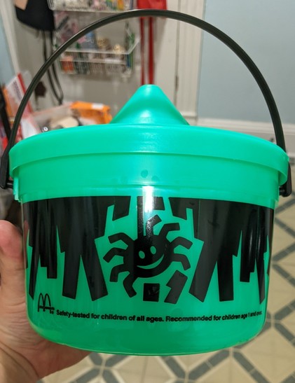 The back of the original green witch pail from the McDonalds Happy Meals with a smiling spider