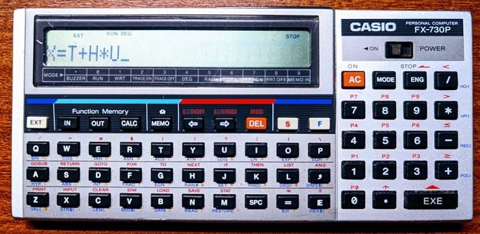 A Casio FX-730p pocket-computer. This computer has a single line display above a QWERTY keyboard and a numpad to the right. Above the keyboard are prominent function keys for the Function Memory and Memo-features.