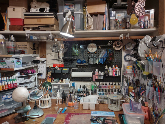 A photo of a very full, but organized, closet craft station. 