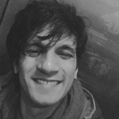 A black-and-white selfie of me smiling in an elevator.