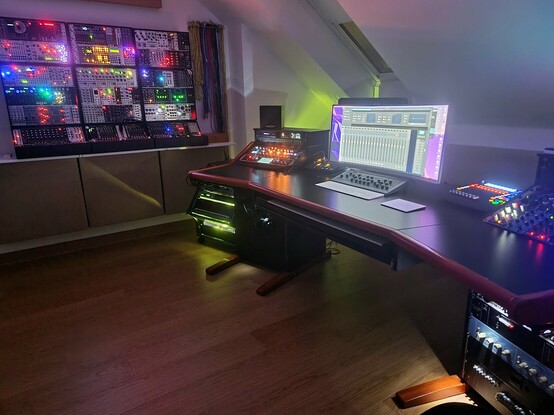 A music studio at night, with a plethora of multicoloured lights flashing invitingly.