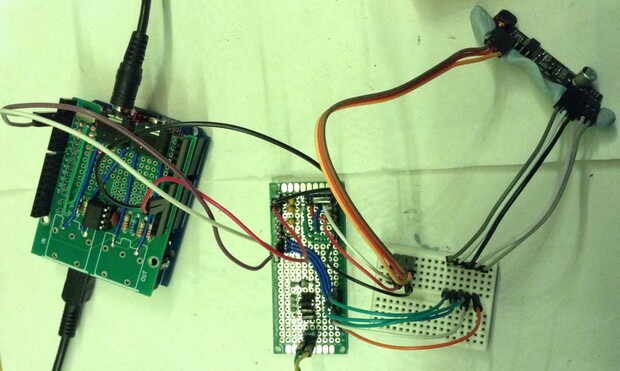 An Arduino Uno with MIDI interface on the left connected to a protoboard circuit (centre) supporting the KS0835F subscriber line module on the right.