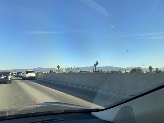 Carpool/Express Lanes heading to LA Downtown. With traffic. With clear skies. Downtown LA skyline and a couple of Palm Trees