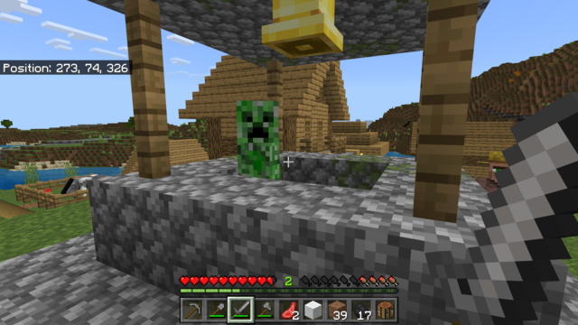 Minecraft creeper bobbing up and down in a village's central well.