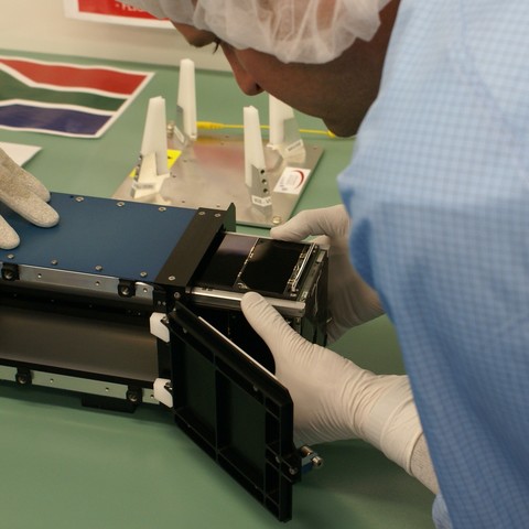 Inserting FUNcube in to the ISIPOD by me. The Material Science Experiment (MSE) silver CubeSat rails and silver strip visible
