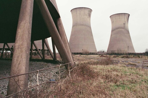 some old hyperboloid concrete power-station cooling towers and scrubby wasteland