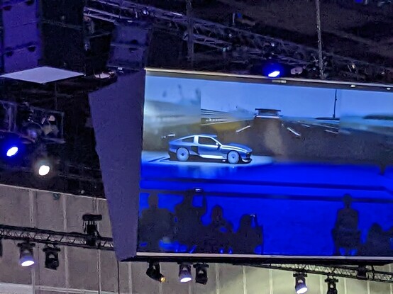 Taking a picture of presentation from a hanging display above the crowd 