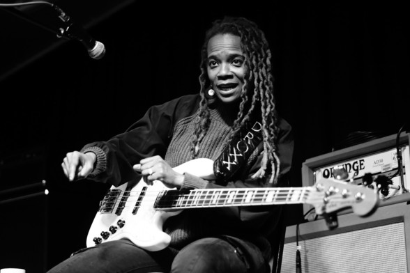 Black and white photo of bassist, vocalist, composer and producer Divinity Roxx with a Fender bass guitar 