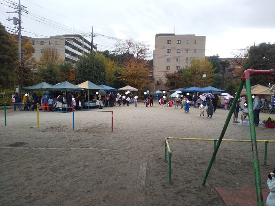 A large square in Japan with tents installed and people browsing around.