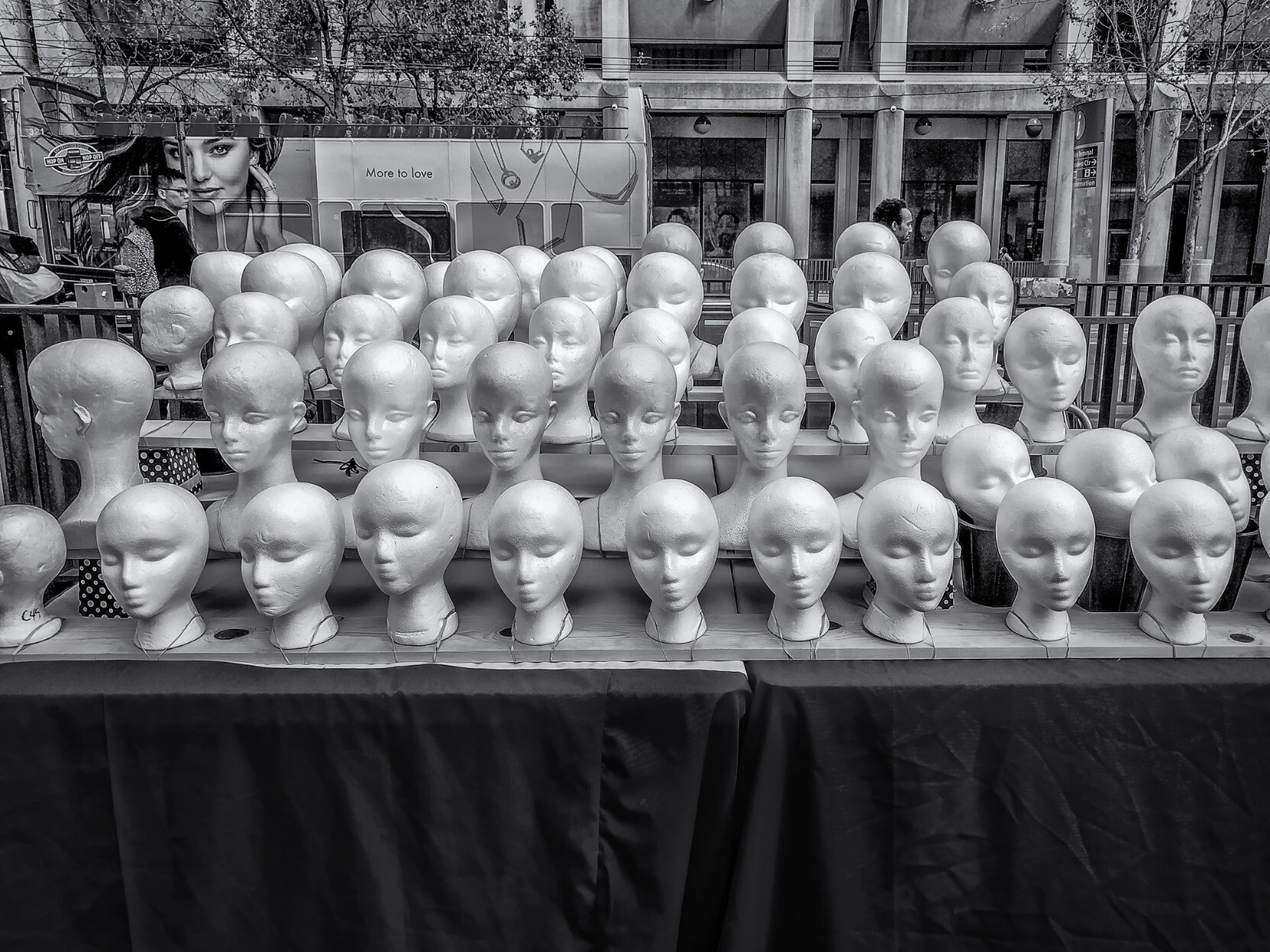 Styrofoam heads used for modeling caps on street vendor's table in San Francisco.