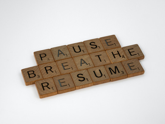 Pieces of wood scrabble with words:
Pause, Breathe. Resume.
Picture by Brett Jordan at Unsplash.