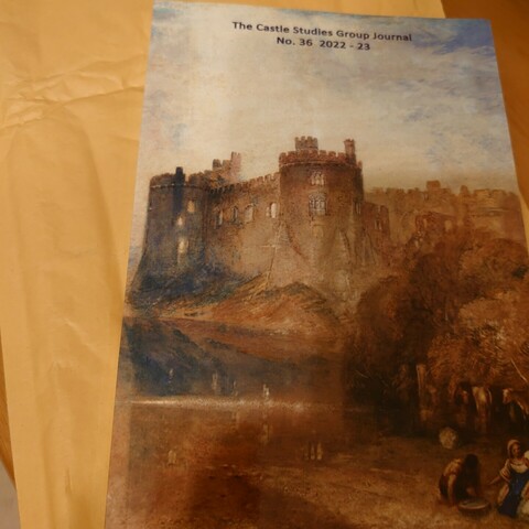 A journal sat in top of an envelope. The front cover of the journal reads 'The Castle Studies Group Journal No. 36 2022-23'