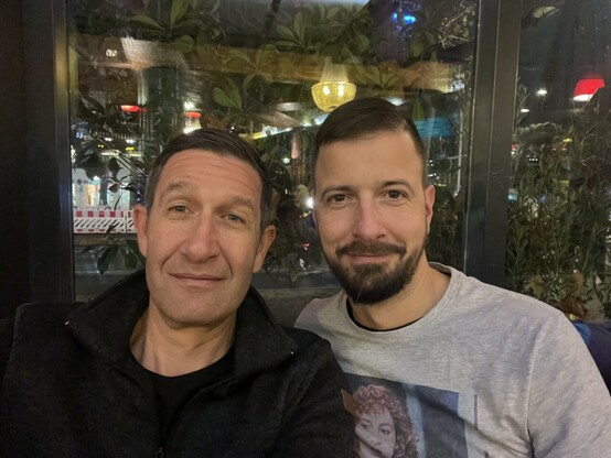 Two male guys at a restaurant 