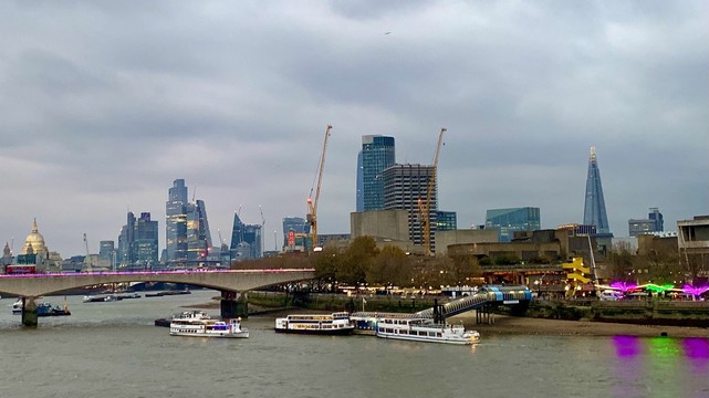 A picture of London from the Embankment - Golden Jubilee bridge, the sky is cloudy but the picture is colourful, especially near the riverside 