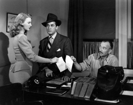 Actors Robert Armstrong and Edward Norris with actress Jean Gillie in the 1946 noir film “Decoy“.
