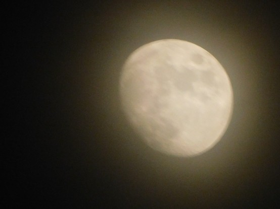Waxing gibbous Moon, through high thin clouds, on December 4, 20 22.