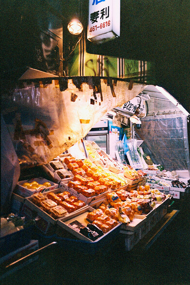 Night photo of a fruit stand in Shibuya. Kodak Portra 400VC with Fuji GA645W.