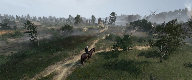 A bird's eye shot of Geralt on horseback, looking out over a narrow dirt road and into the early morning fog over the rural hamlet of White Orchard