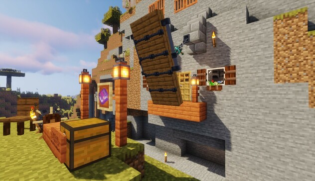 Minecraft screenshot: a lifted drawbridge preventing access to a fortress door over a trench. 