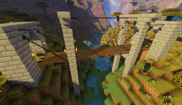 Minecraft screenshot: a multi part suspension bridge crossing a deep river canyon with lots of chains. 
