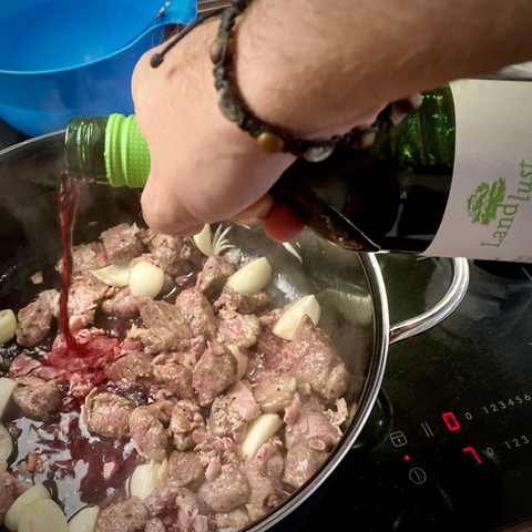 Deglazing the pot with red wine
