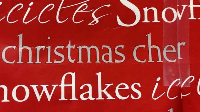 A Christmas present wrapped so that “Christmas Cheer” overlaps to read “Christmas Cher”