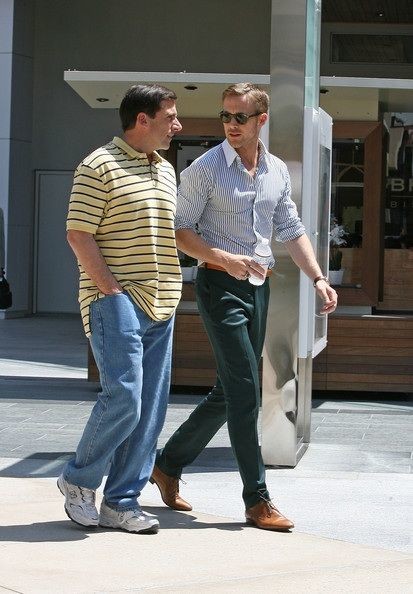 Steve Carell looking frumpy in baggy, dorky clothes walking next to a stylish and fit Ryan Gosling in a scene from the movie "Crazy, Stupid Love"