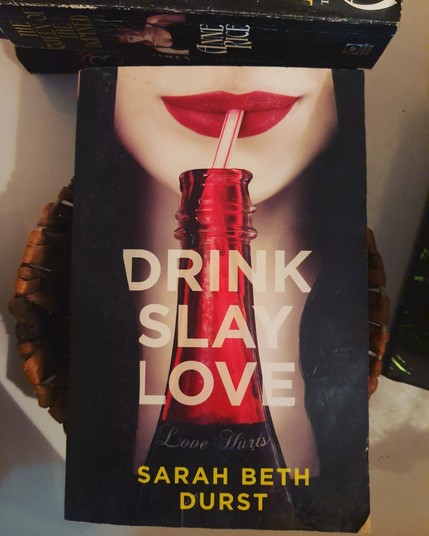 Red lips sipping from a red glass bottle, full of, yep you guessed it, red stuff. Dunno about the drink but the cover is totes yum!