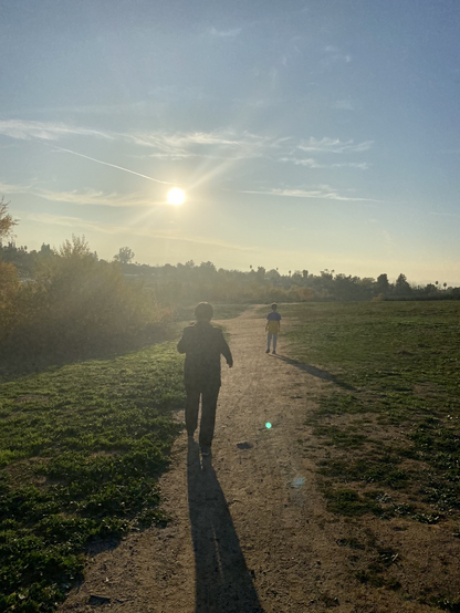 Mom and son walking into the sun