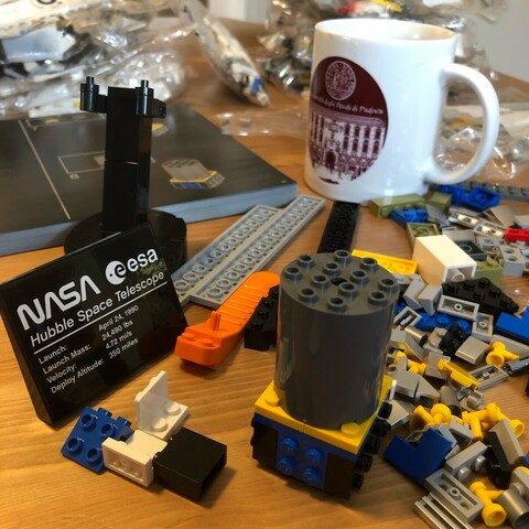 A bunch of LEGO pieces on a table. 