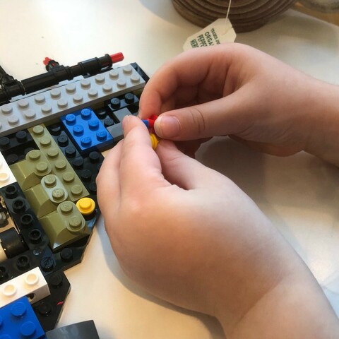Closeup of 4yo snapping LEGO parts together. 