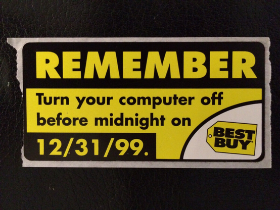A vintage sign from Best Buy that reads REMEMBER: Turn your computer off before midnight on 12/31/99.